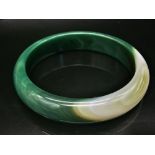 A Green and White Swirl Chinese Jade Bracelet. 65mm inner diameter. 16mm width.
