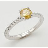 18K WHITE GOLD DIAMOND SOLITAIRE RING WITH DIAMOND SHOULDERS. 0.42CT VIVID YELLOW MAIN STONE.