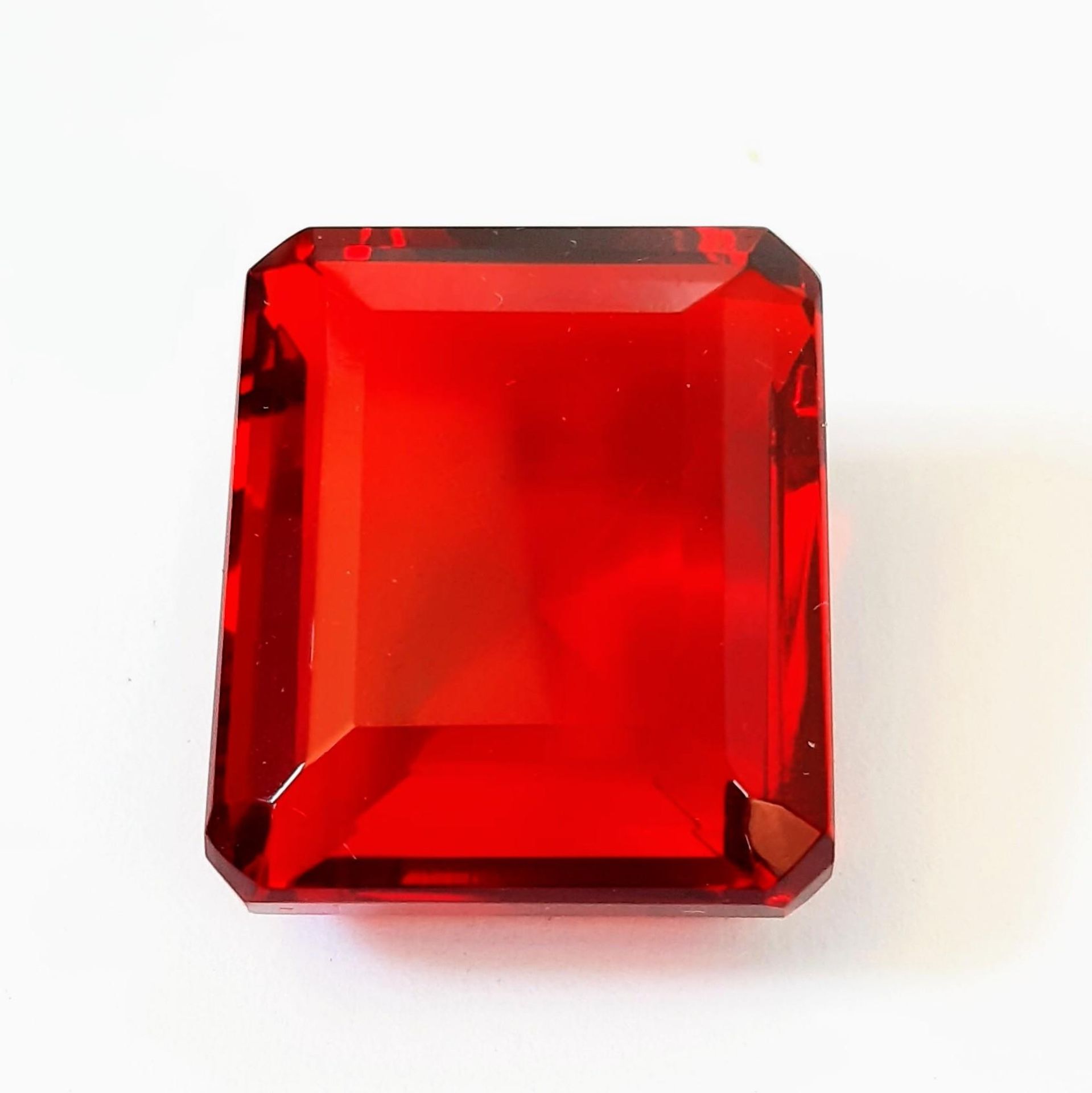 A beautiful, but unidentified, large (58 carats) red stone. Emerald cut, with no inclusions,