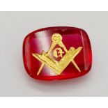 A 3.5ct Faceted Ruby with a Gold Tooled Masonic Emblem.