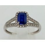 A Blue Sapphire and Diamond Ring. Size: P