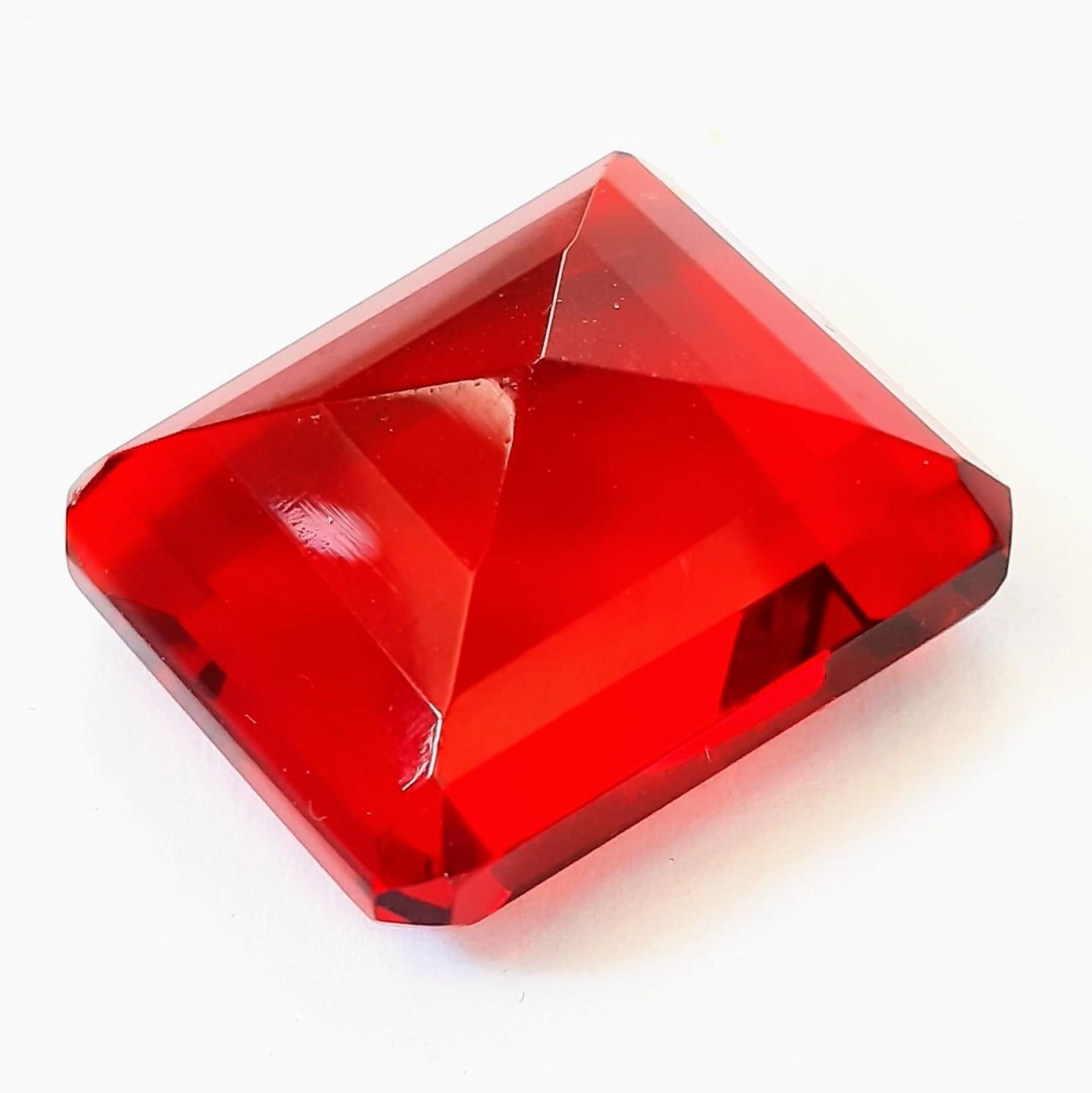 A beautiful, but unidentified, large (58 carats) red stone. Emerald cut, with no inclusions, - Image 2 of 3