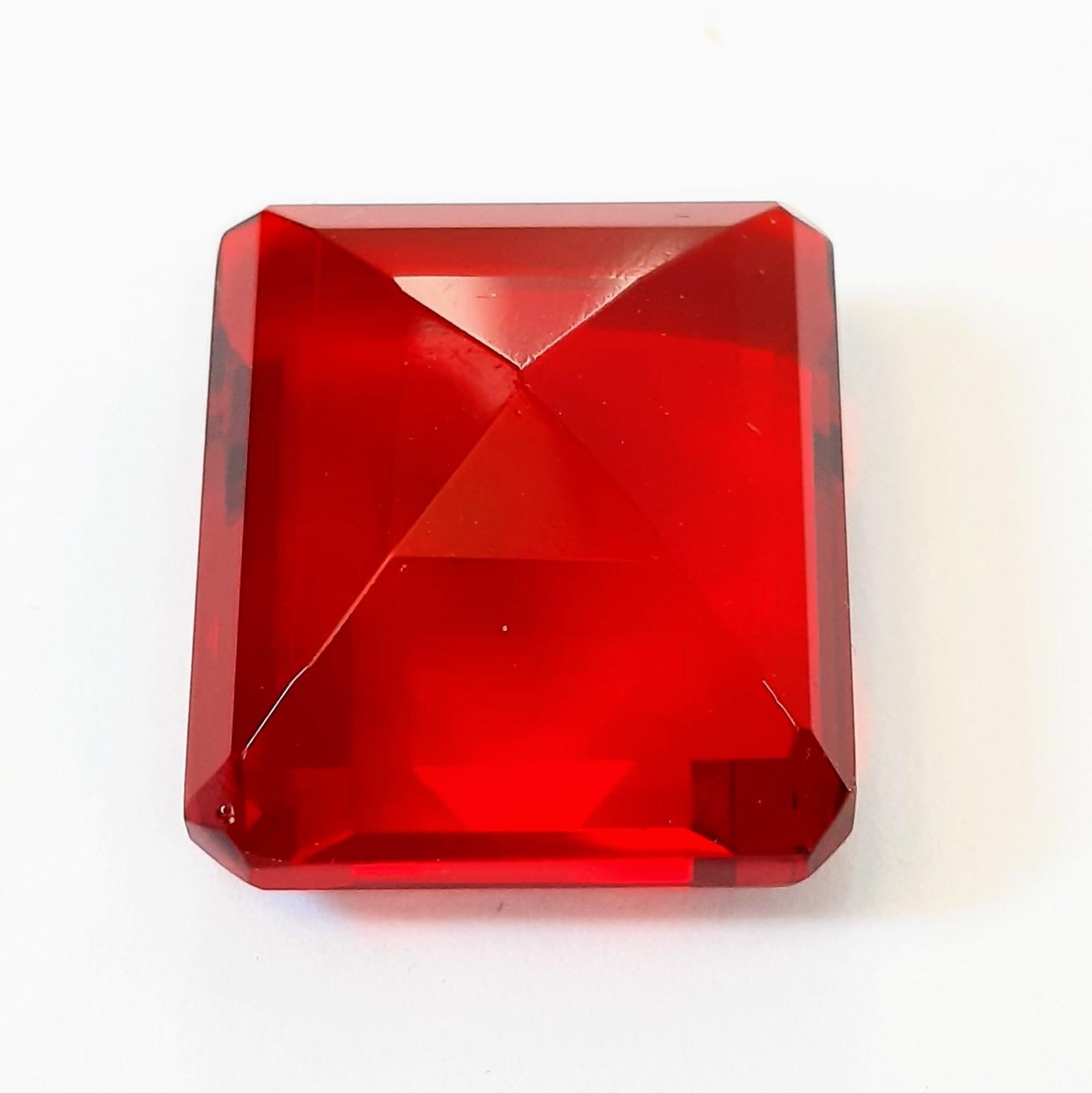 A beautiful, but unidentified, large (58 carats) red stone. Emerald cut, with no inclusions, - Image 3 of 3