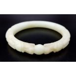 An Antique Chinese Dragon-Head Jade Bangle. Hand-carved double dragon head design. 65mm inner