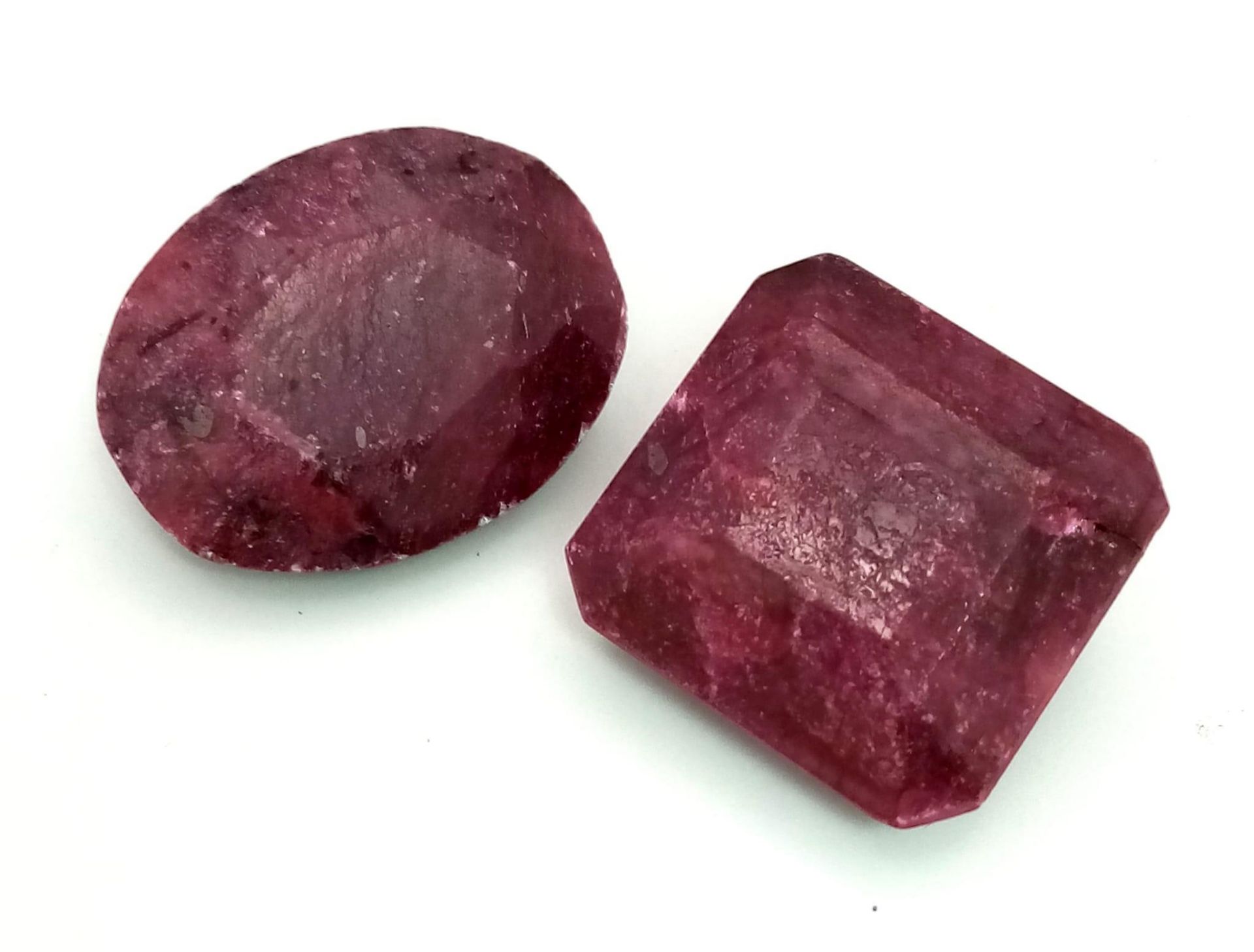 Lot of 2 large Rubies. Include: A Square 40.050cts and A 34ct Oval Ruby. Color enhanced, earth mined