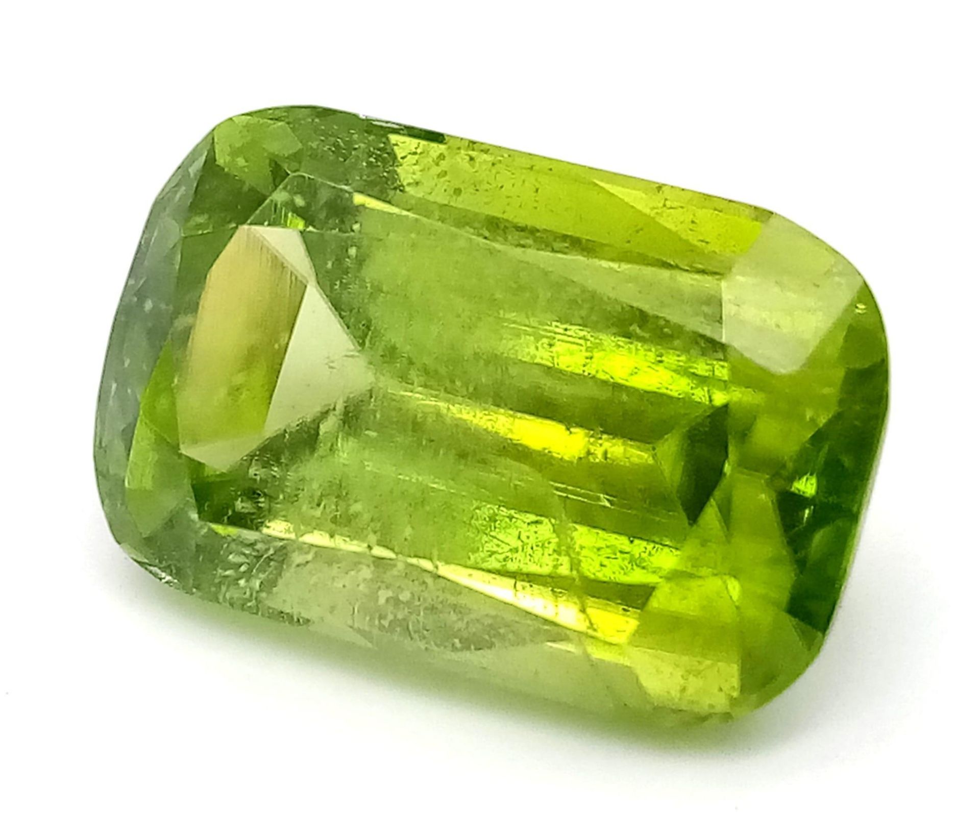 A Rare 9.97ct Pakistani Peridot. Cushion cut with no inclusions. Comes with a GFCO Swiss