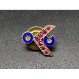 Victory ruby and diamond lapel pin with blue enameling set in 10k gold. 15mm. 2.34g total weight.