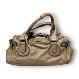 A Chloe Beige Leather Handbag. Baguette shaped. Silver-tone hardware. Spacious textile interior with