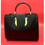 A Salvatore Ferregamo Black Leather Handbag. Black snakeskin with gold-tone hardware exterior.