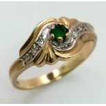 A 9K Yellow Gold Emerald and Diamond Swirl Decorative Ring. Size O. 2.2g total weight.