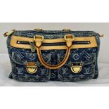 A Louis Vuitton Monogram Blue Denim Handbag. Brown leather trim and handles. Two exterior pockets