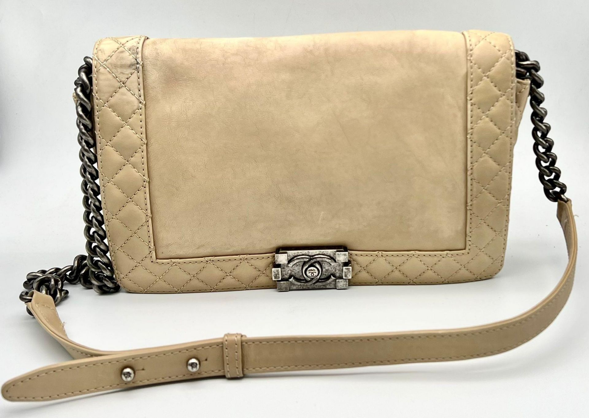A Chanel Beige Leather Crossbody Flap Bag. Soft leather with gun-metal finish hardware. Textile