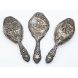A Pair of Antique Henry Matthews Sterling Silver Repousse Hair Brushes and Hand Mirror. Identical