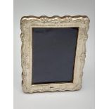 A Sterling Silver and Wood Photo Frame. 12cm x 16cm. Good condition.