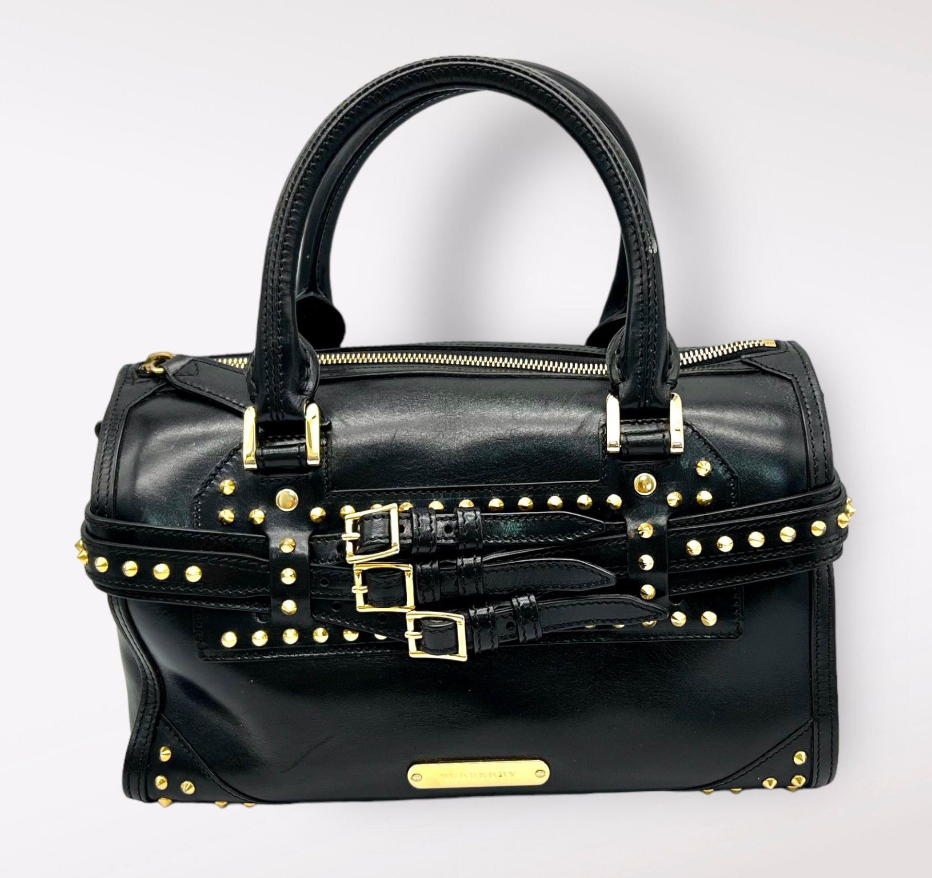 A Burberry Black Leather Stud Handbag. Adjustable studded shoulder strap. Gold-toned hardware. Three