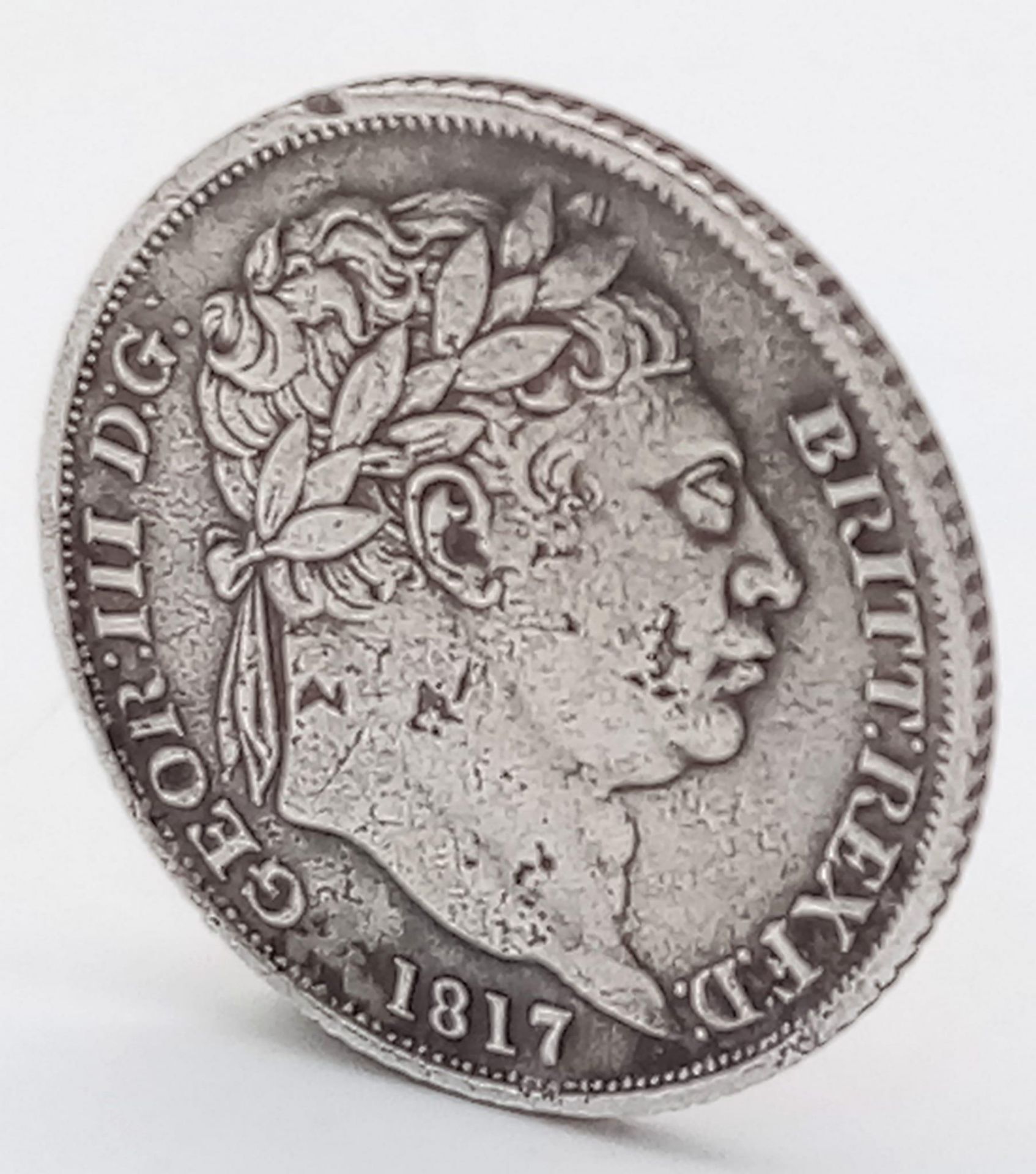 An 1817 George III Silver Sixpence Coin. Decent grade but please see photos.