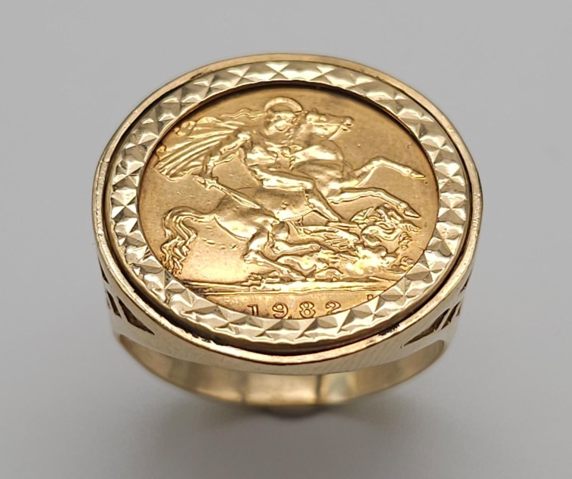22k yellow gold half sovereign coin, dated 1982 with Queen Elizabeth, set into a 9k yellow gold ring