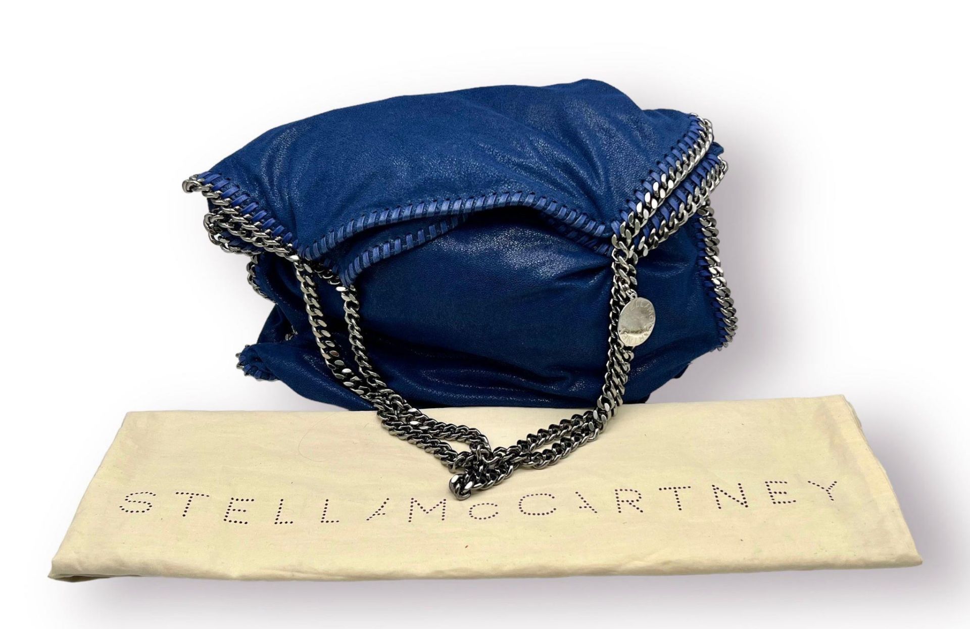 A Stella McCartney Falabella Electric Blue Tote Bag. Silver-tone chain shoulder straps. Magnetic