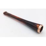 An amber ladies cigarette smoking pipe with a rose gold ring around the cigarette end. Length: 9 cm.