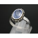 A 1.84ct Oval Cut Blue Sapphire ring with Rose-Cut Diamond Surround - 0.16ct. Set in 925 silver.