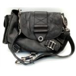 A Christian Dior Black Leather Handbag. Silver tone hardware. Chunky clasp lock. Two exterior side