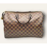 A Louis Vuitton Speedy Canvas Monogram Bag with Dust Cover. Checked LV canvas with padlock. Red