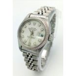 A LADIES STAINLESS STEEL ROLEX OYSTER PERPETUAL DATEJUST WITH DIAMOND NUMERALS ON A WHITE FACE. 26mm