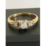 14 carat GOLD RING set with sparkling 0.2 carat DIAMOND to centre in stylised mount and having