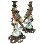 A Pair of Antique Porcelain and Bronze Parrot Candlestick Holders. Ornate brass base. Red, green and