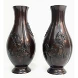 A Pair of Antique Chinese Bronze Vases with Ornate Sage and Calligraphy Decoration. 24cm tall. In