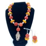 A substantial, Tibetan silver, Buddhist, butterscotch amber and red coral necklace and earrings