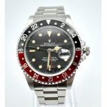 A ROLEX GMT-MASTER II IN STAINLESS STEEL WITH DATE BOX, BLACK DIAL AND RED AND BLACK ROTATING BEZEL.