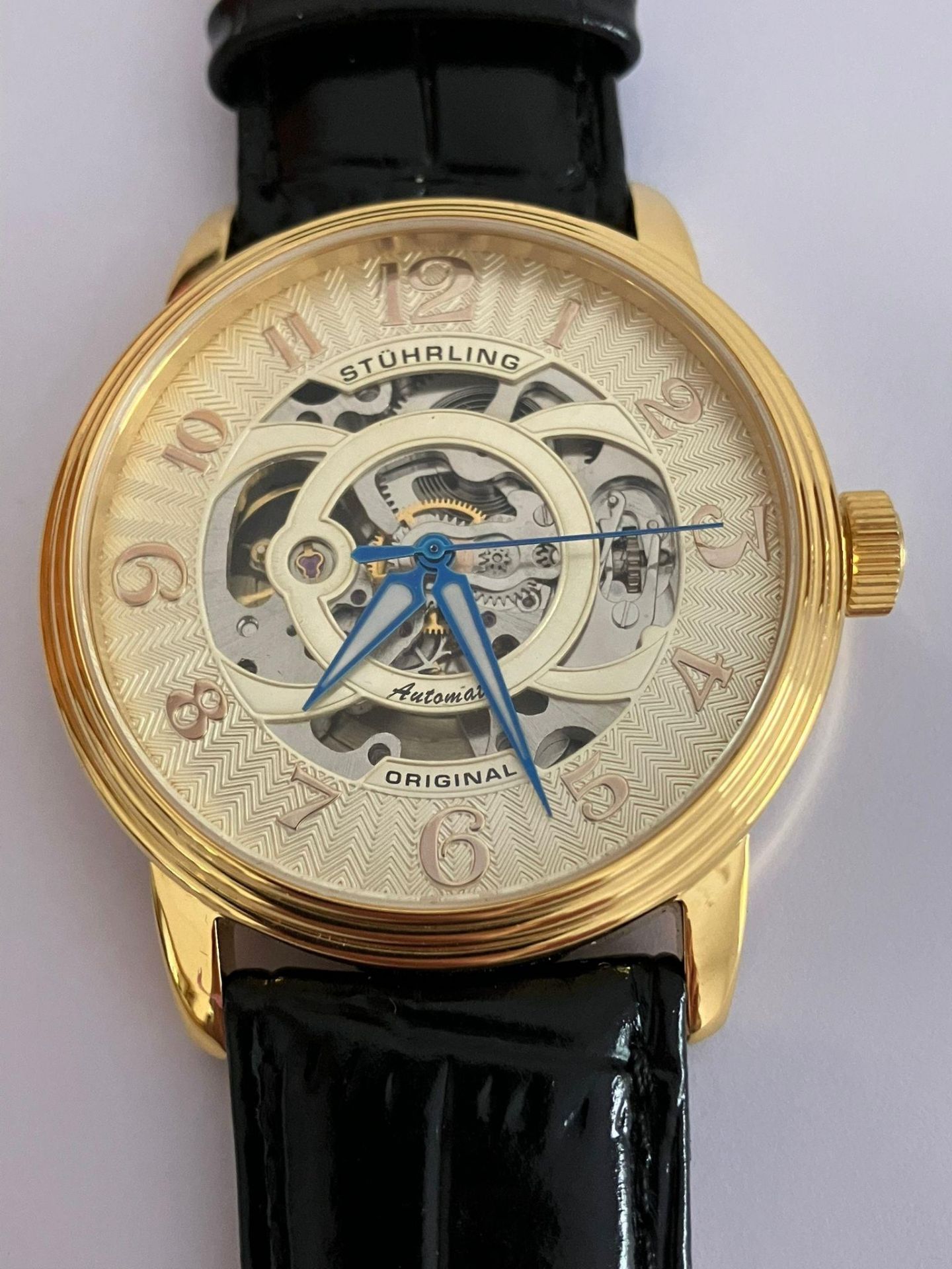 Gentlemans AUTOMATIC SKELETON WRISTWATCH from MAX STUHRLING of NEW YORK. Finished in gold tone and
