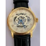 Gentlemans AUTOMATIC SKELETON WRISTWATCH from MAX STUHRLING of NEW YORK. Finished in gold tone and