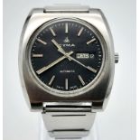 A Vintage CYMA Automatic Gents Watch. Stainless steel strap and case - 38mm. Black dial with day/