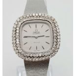 A STUNNING LADIES OMEGA "DE VILLE" IN 18K WHITE GOLD WITH A DOUBLE ROW OF DIAMONDS ON THE BEZEL.