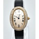 An 18K Gold and Diamond Ladies Cartier Watch. Black leather strap. Gold case - 23mm width with a