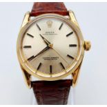 A Vintage Rolex 14K Gold Oyster Perpetual Gents Watch. Brown leather strap. 14k gold case - 34mm.