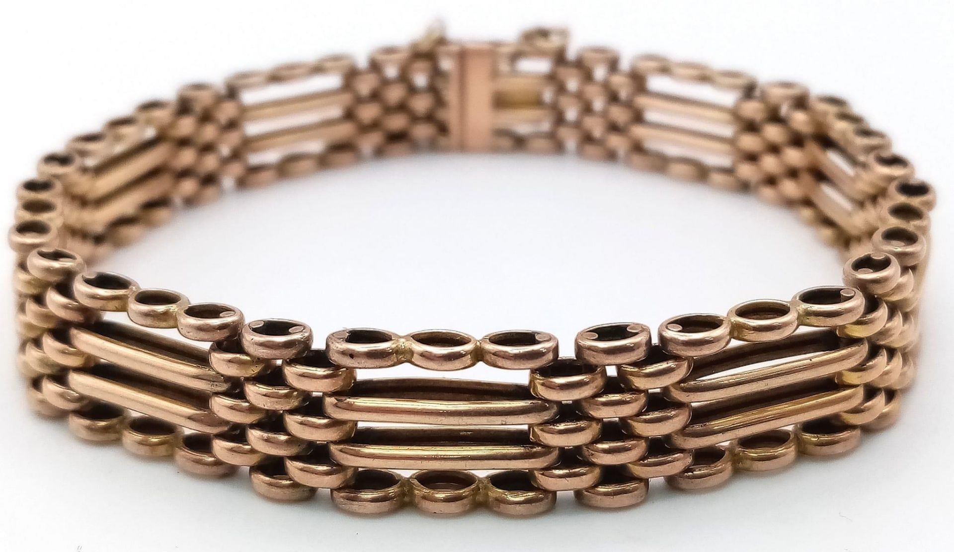 A FOUR ROW VINTAGE SEMI GATE BRACELET IN 9K ROSE GOLD WITH SAFETY CHAIN .17.1gms