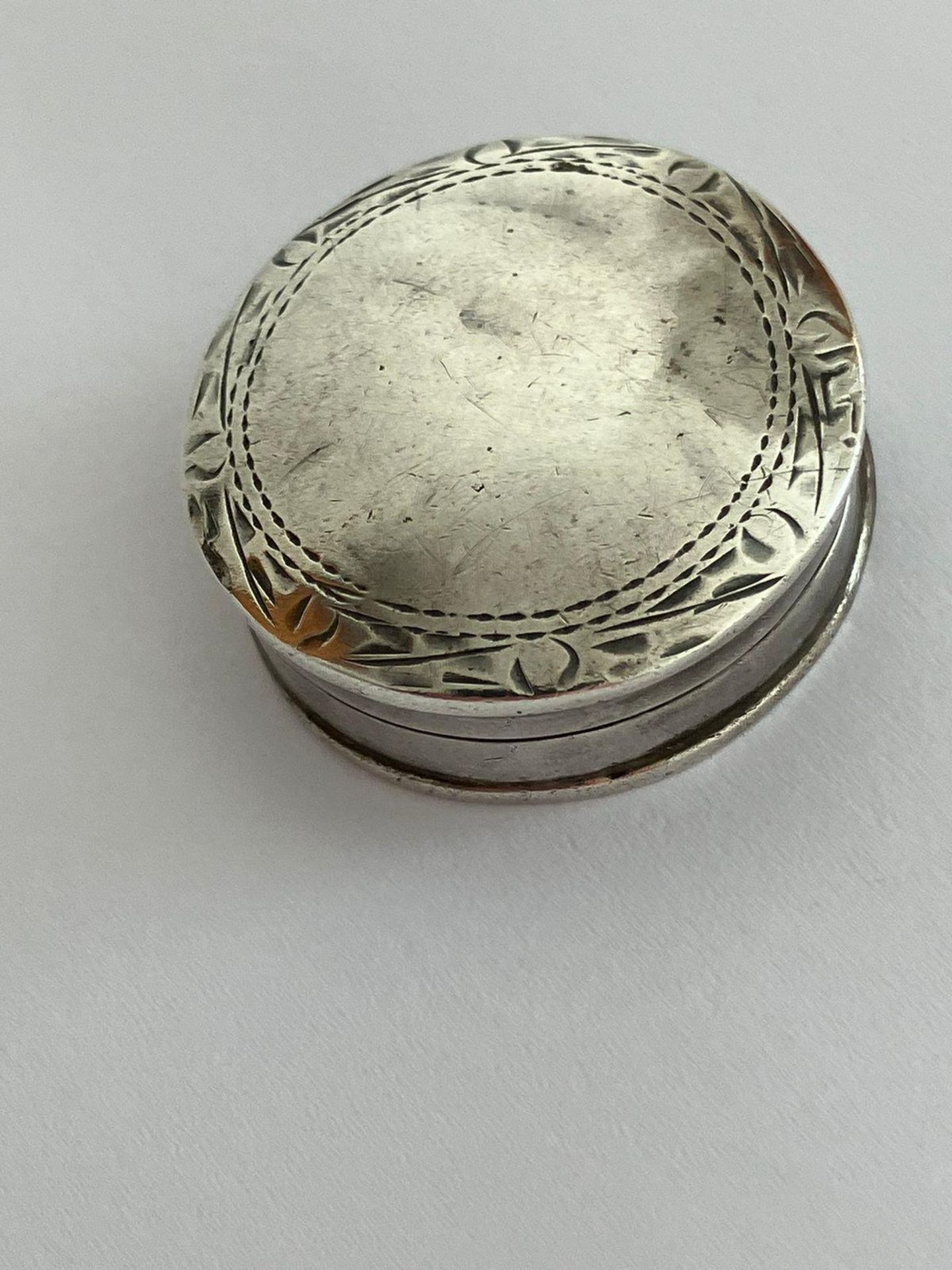 Vintage SILVER PILL BOX in circular form with decorated border. Hallmark on base.