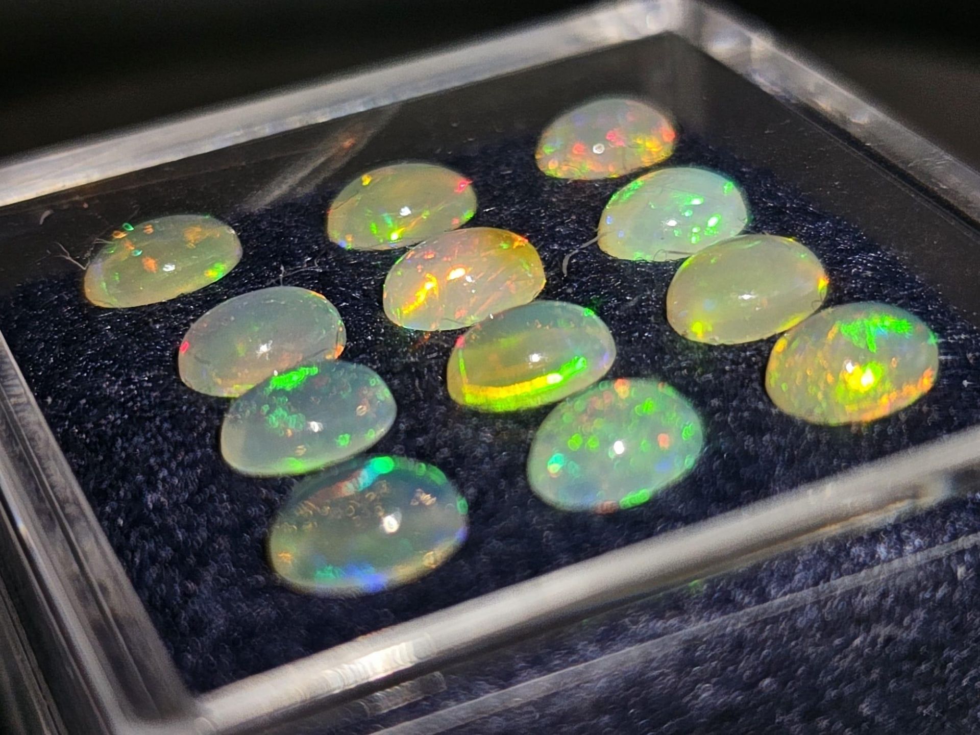 A group of twelve Australian OPAL oval cabochons, each 7 x 5 x 3 mm. Excellent iridescent hues. - Image 2 of 4