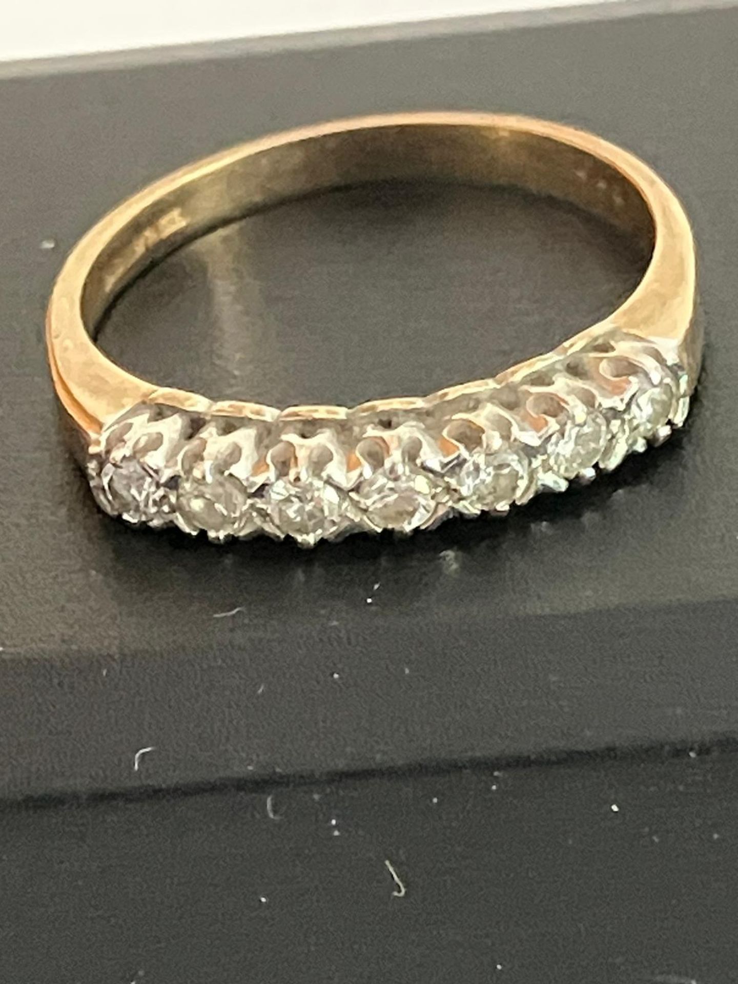 9 carat GOLD and DIAMOND RING Having seven clear white sparkling DIAMONDS set to top in line