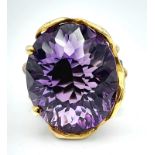 A glorious, vintage sterling silver ring with 18 K yellow gold accents and an impressive amethyst