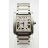 A CARTIER TANK stainless steel ladies watch with blue sapphire on winder. White dial with Roman