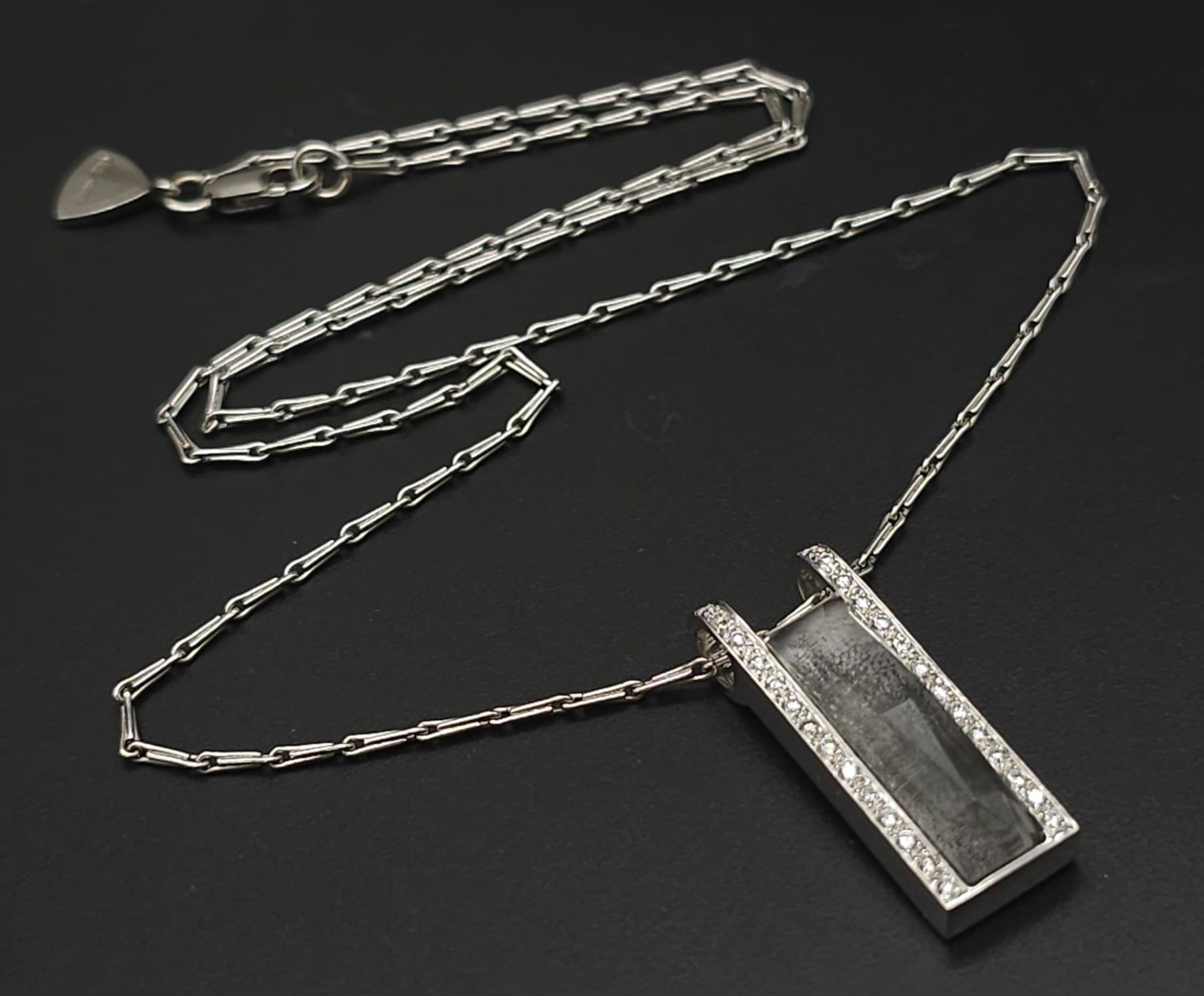 An 18K White Gold Rutilated Quartz and Diamond Pendant on an 18K White Gold Link Necklace. A
