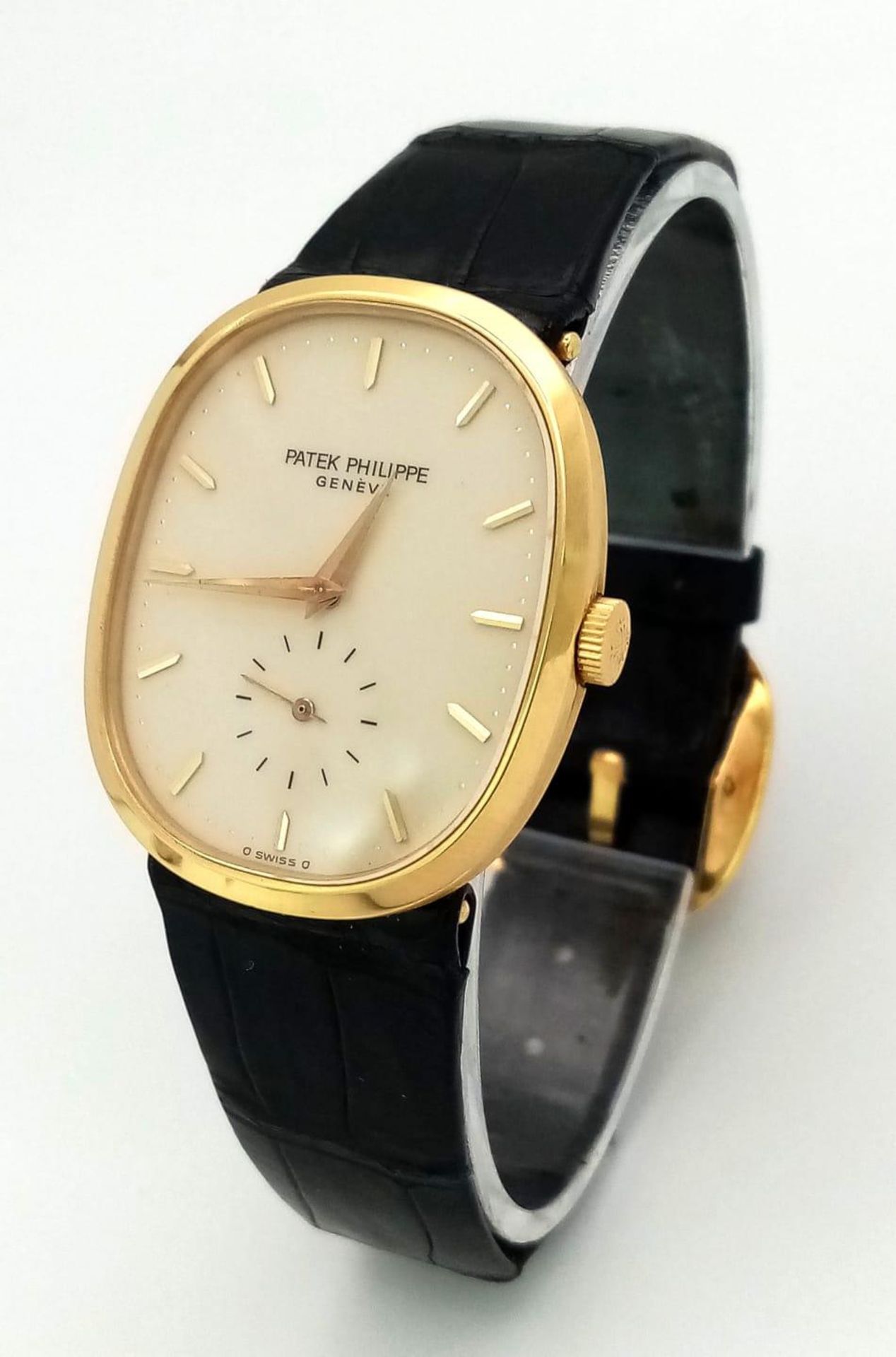 A Vintage Patek Phillipe 18K Gold Gents Watch. Original black leather strap with 18k gold buckle.