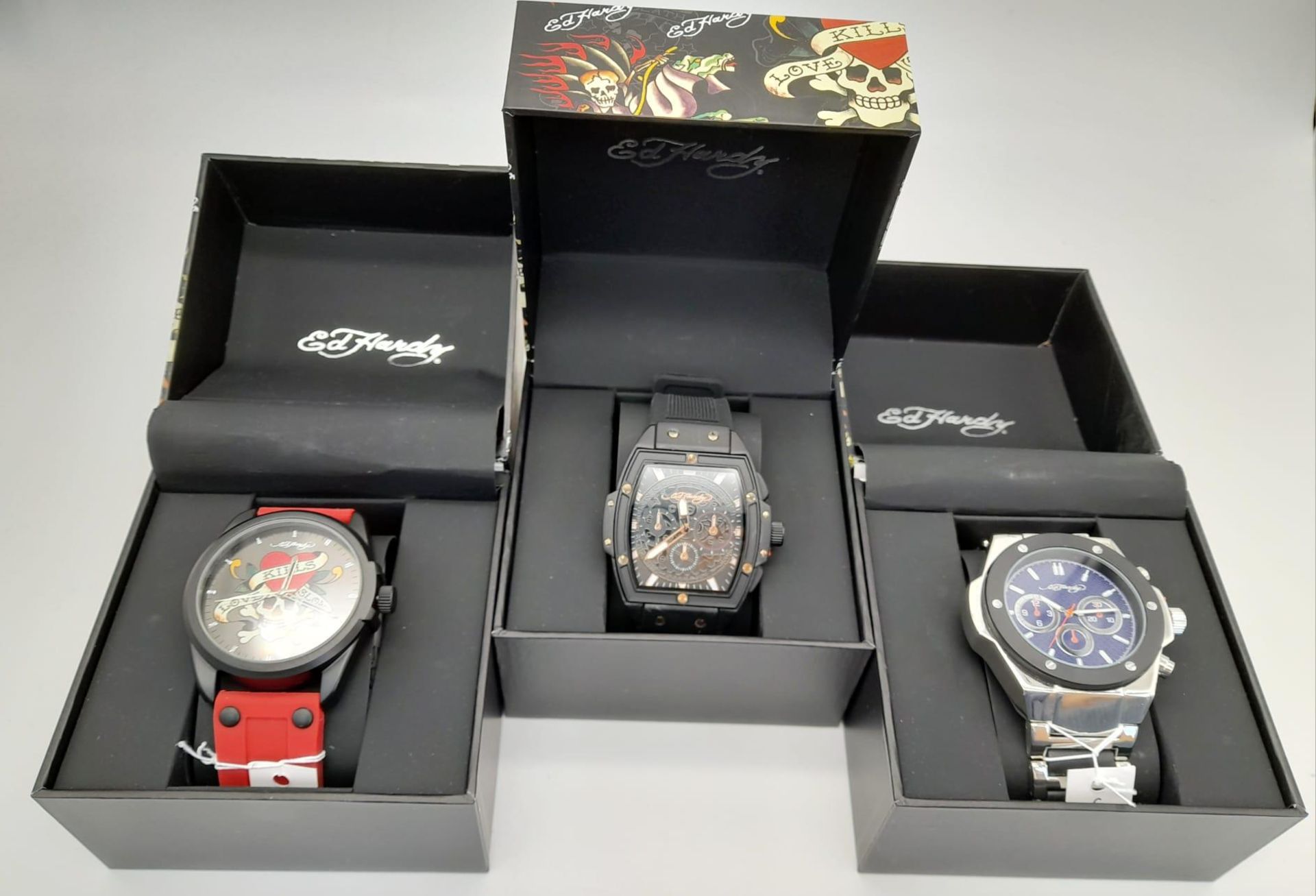 Three Different Style Ed Hardy Skull Quartz Watches. As new, in boxes. All in need of a battery so