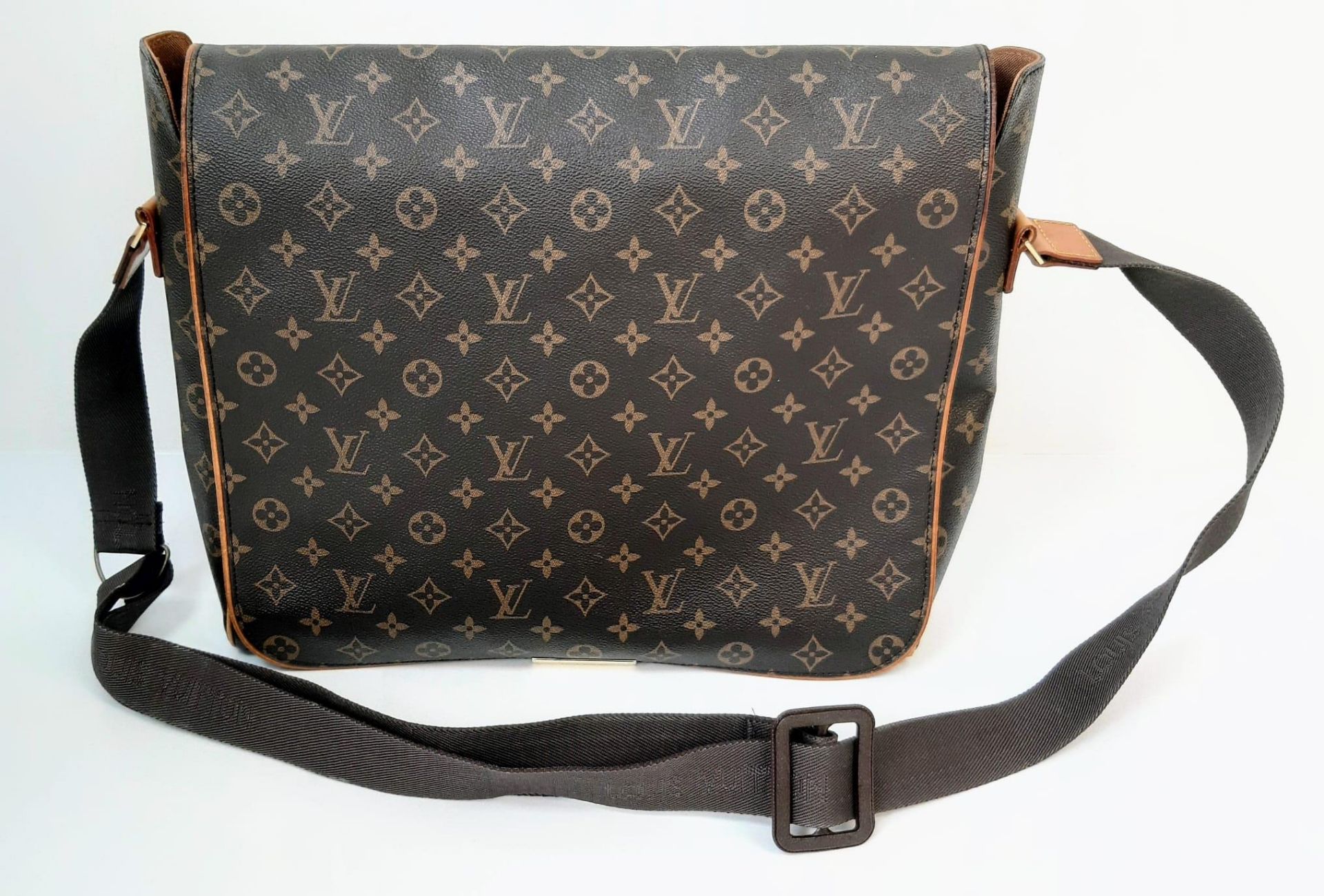 A Louis Vuitton Abbesses Messenger Bag. Monogram canvas exterior with brown leather trim. Sturdy
