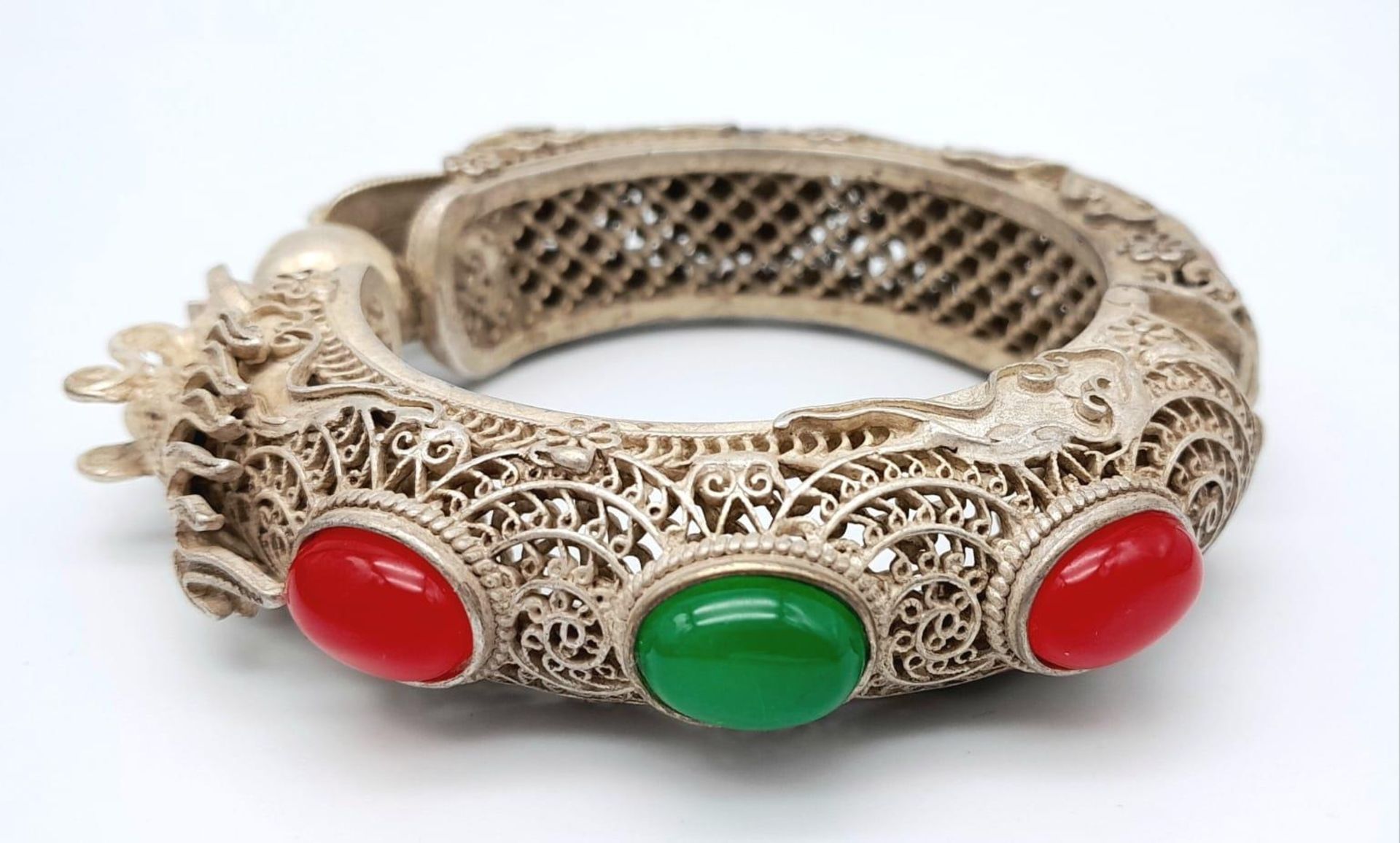 An antique, Chinese silver, filigree bangle, in the shape of two dragons with green and red jade - Image 3 of 4