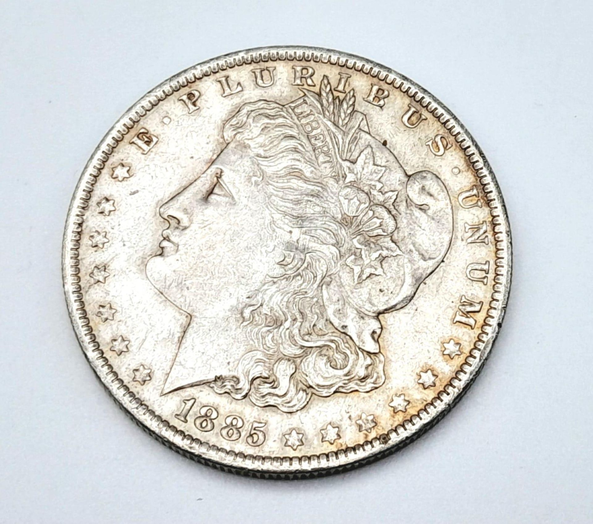 An Extremely Fine Condition 1885 New Orleans Mint Morgan Dollar 26.78 Grams. Graded on Sheldon